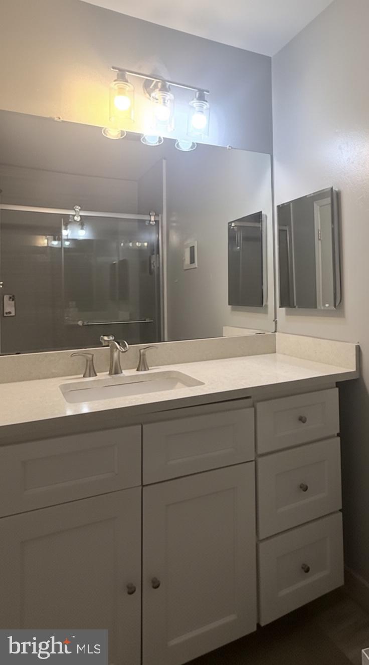 1502 Casino Circle Silver Spring, MD 20906 - Photo 15 of 21 a bathroom with a double vanity sink and mirror