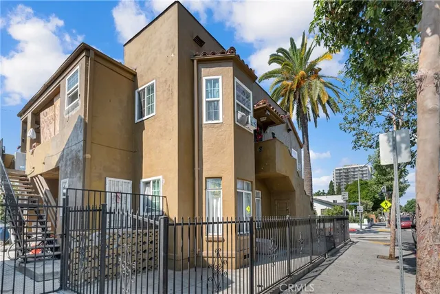 a front view of a house with a tree