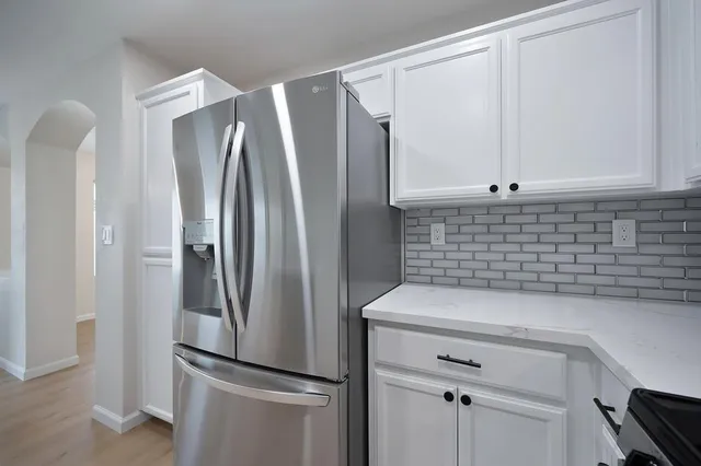 a kitchen with stainless steel appliances a refrigerator and a sink