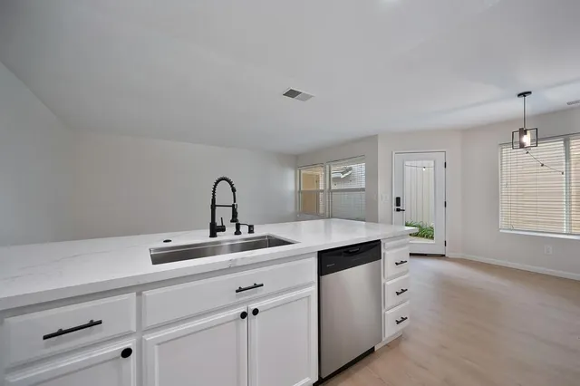a kitchen with a sink and cabinets