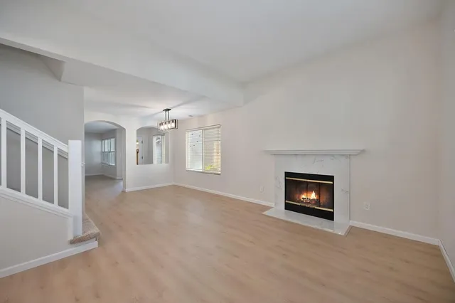 a view of a livingroom with a fireplace and a window