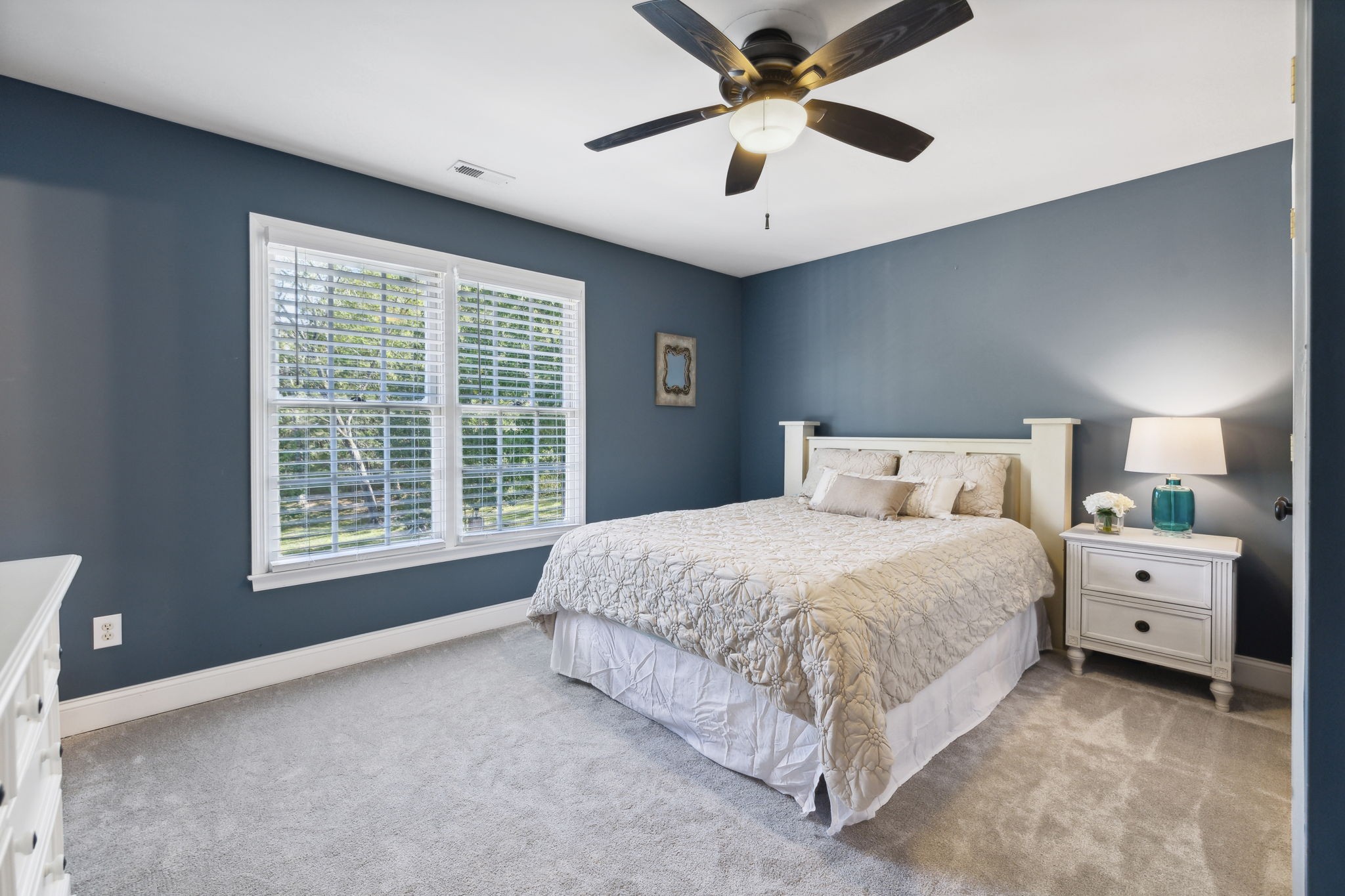 412 Martingale Drive Franklin, TN 37067 - Photo 32 of 56 a spacious bedroom with a large bed and a chandelier fan
