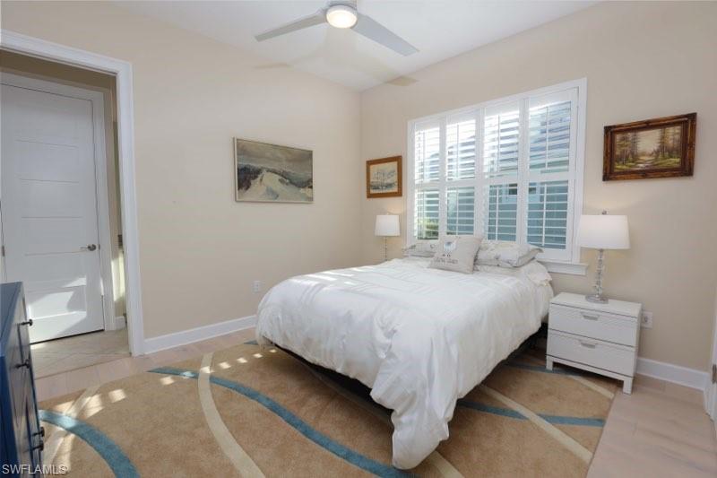 5717 Anegada Drive Naples, FL 34113 - Photo 11 of 37 a bedroom with a bed and a window