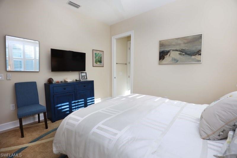 5717 Anegada Drive Naples, FL 34113 - Photo 12 of 37 a bedroom with a bed and a flat screen television