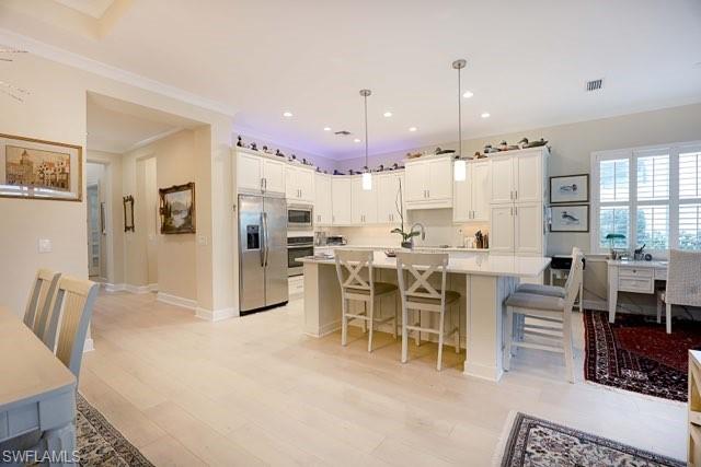 5717 Anegada Drive Naples, FL 34113 - Photo 14 of 37 a large kitchen with a table and chairs