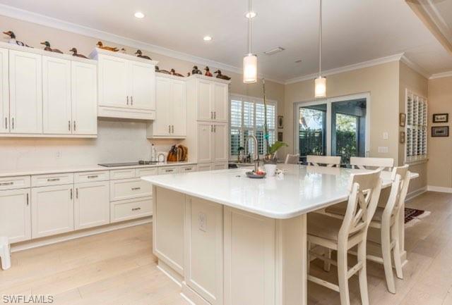 5717 Anegada Drive Naples, FL 34113 - Photo 15 of 37 a kitchen with granite countertop a sink cabinets and stainless steel appliances