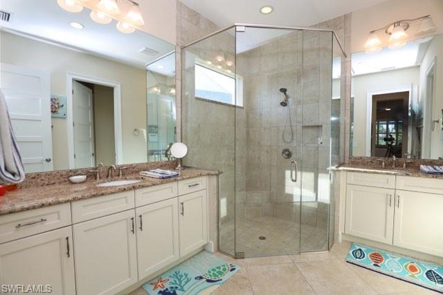 5717 Anegada Drive Naples, FL 34113 - Photo 22 of 37 a bathroom with a granite countertop sink mirror and double