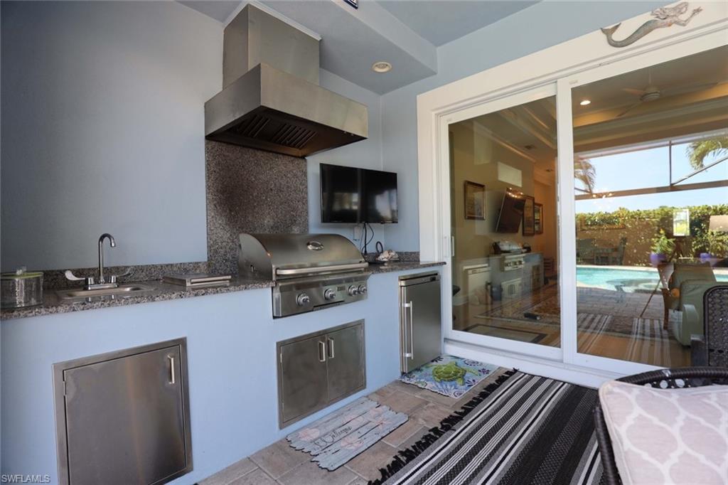 5717 Anegada Drive Naples, FL 34113 - Photo 25 of 37 a kitchen with a stove and a refrigerator