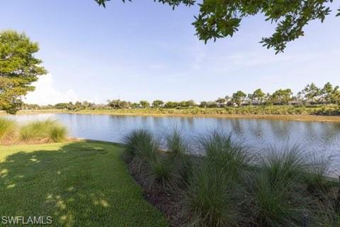 5717 Anegada Drive Naples, FL 34113 - Photo 36 of 37 a view of a lake with houses in the back