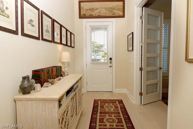 5717 Anegada Drive Naples, FL 34113 - Photo 4 of 37 a hallway with cabinets