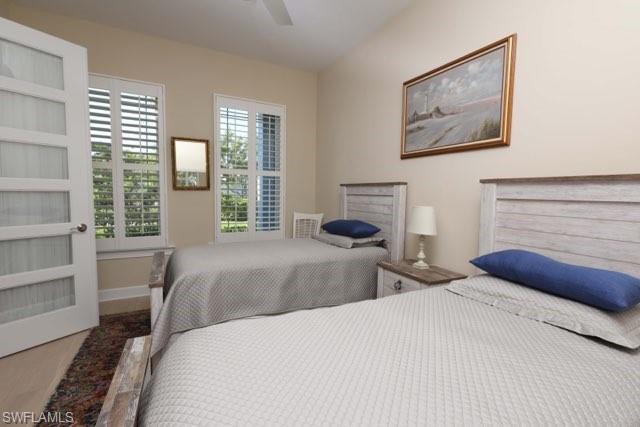5717 Anegada Drive Naples, FL 34113 - Photo 6 of 37 a bedroom with a large bed and a large window
