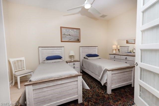 5717 Anegada Drive Naples, FL 34113 - Photo 7 of 37 a bedroom with a bed and a desk