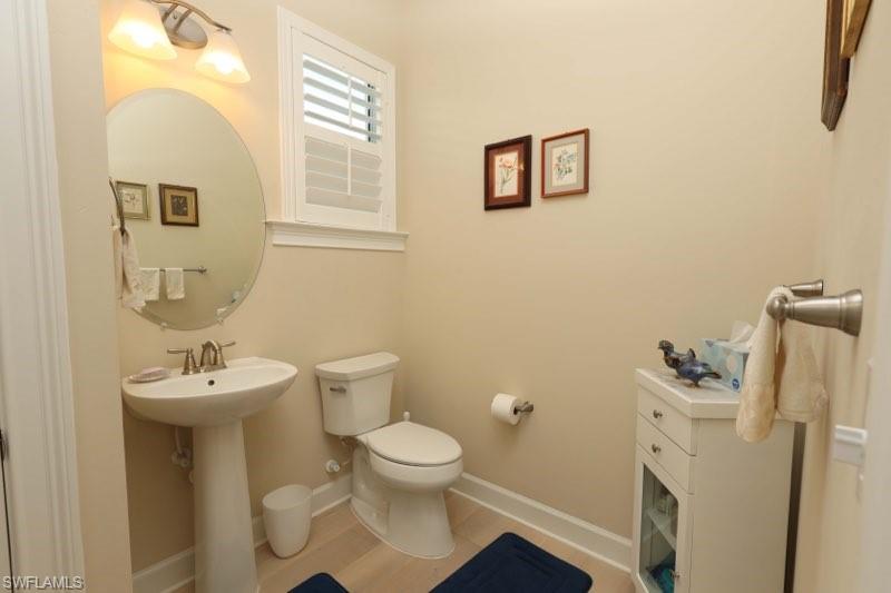 5717 Anegada Drive Naples, FL 34113 - Photo 9 of 37 a bathroom with a sink mirror and toilet