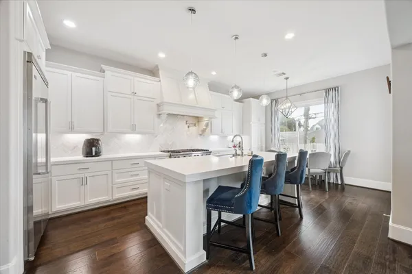 a kitchen with a table chairs stove and cabinets