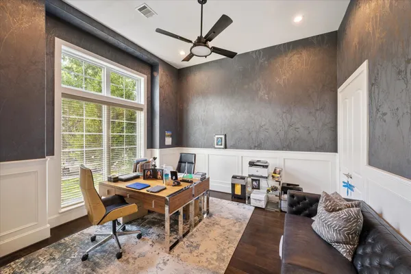 a reading room with furniture and a window