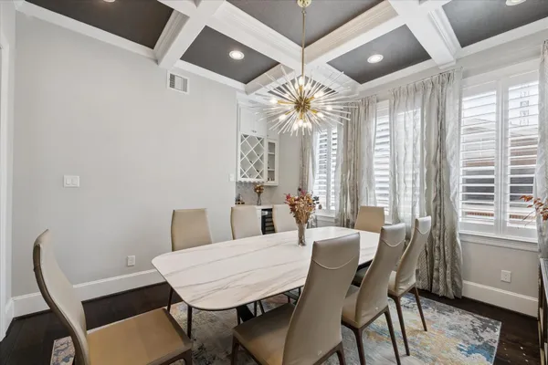 a view of a dining room with furniture wooden floor and chandelier