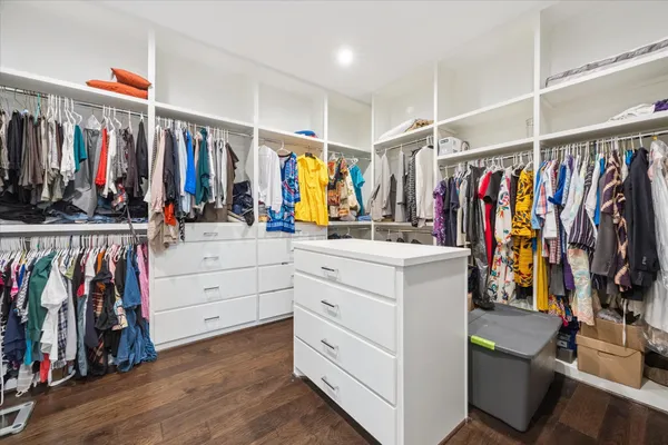 a view of walk in closet with clothes