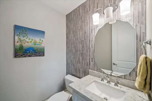 a bathroom with a sink and a mirror with toilet