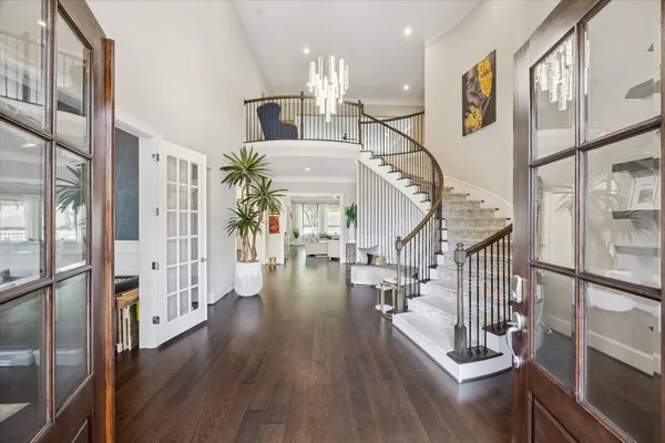 a view of entryway and hall with wooden floor