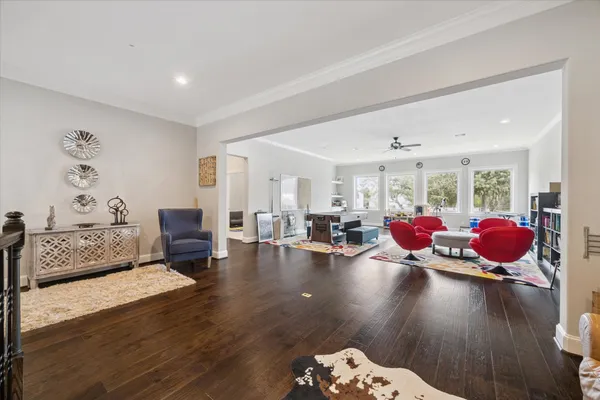 a living room with furniture and wooden floor