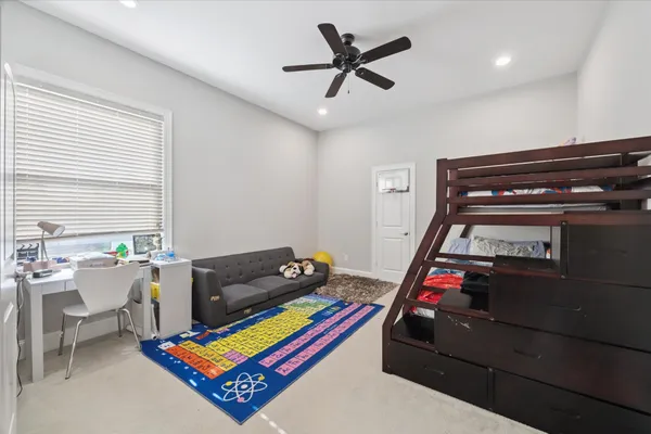 a bedroom with furniture and a wooden floor