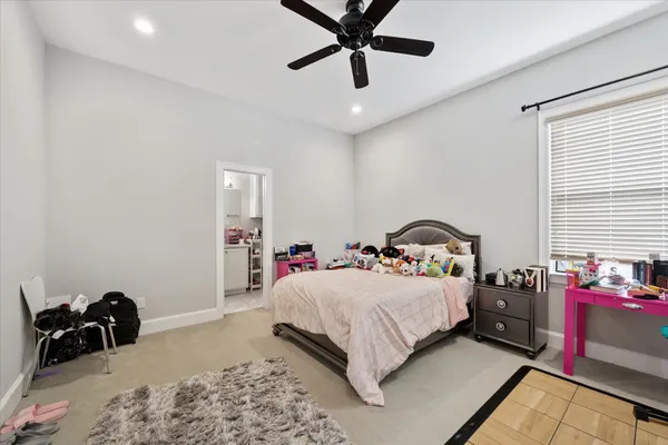 a bedroom with a bed and a dresser