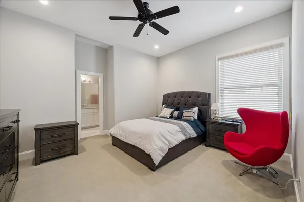 a bedroom with a bed chair and window