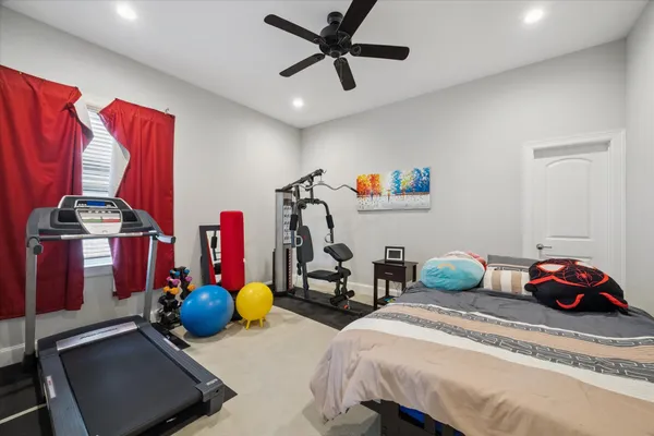 a bedroom with bed and a chandelier