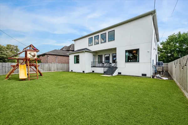 a backyard of a house with table and chairs