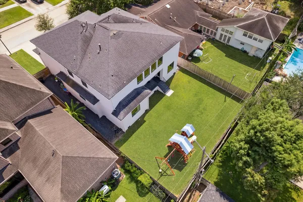 an aerial view of a house with a garden and swimming pool