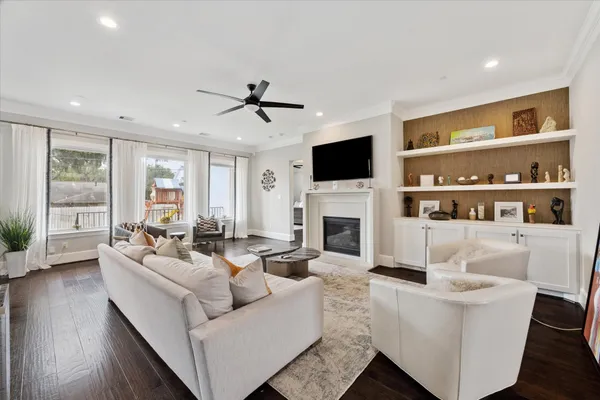 a living room with fireplace furniture and a flat screen tv