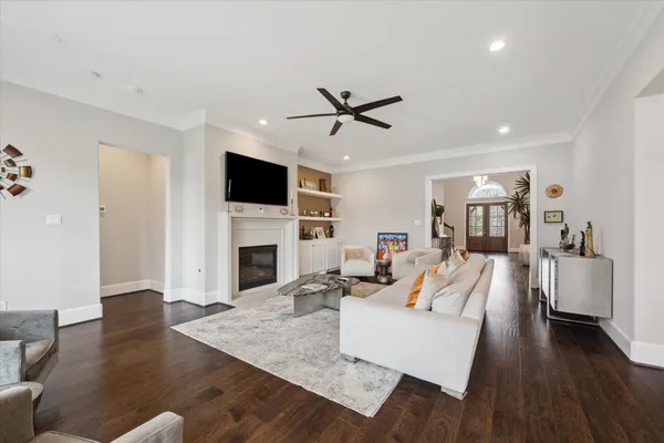 a living room with fireplace furniture and a flat screen tv