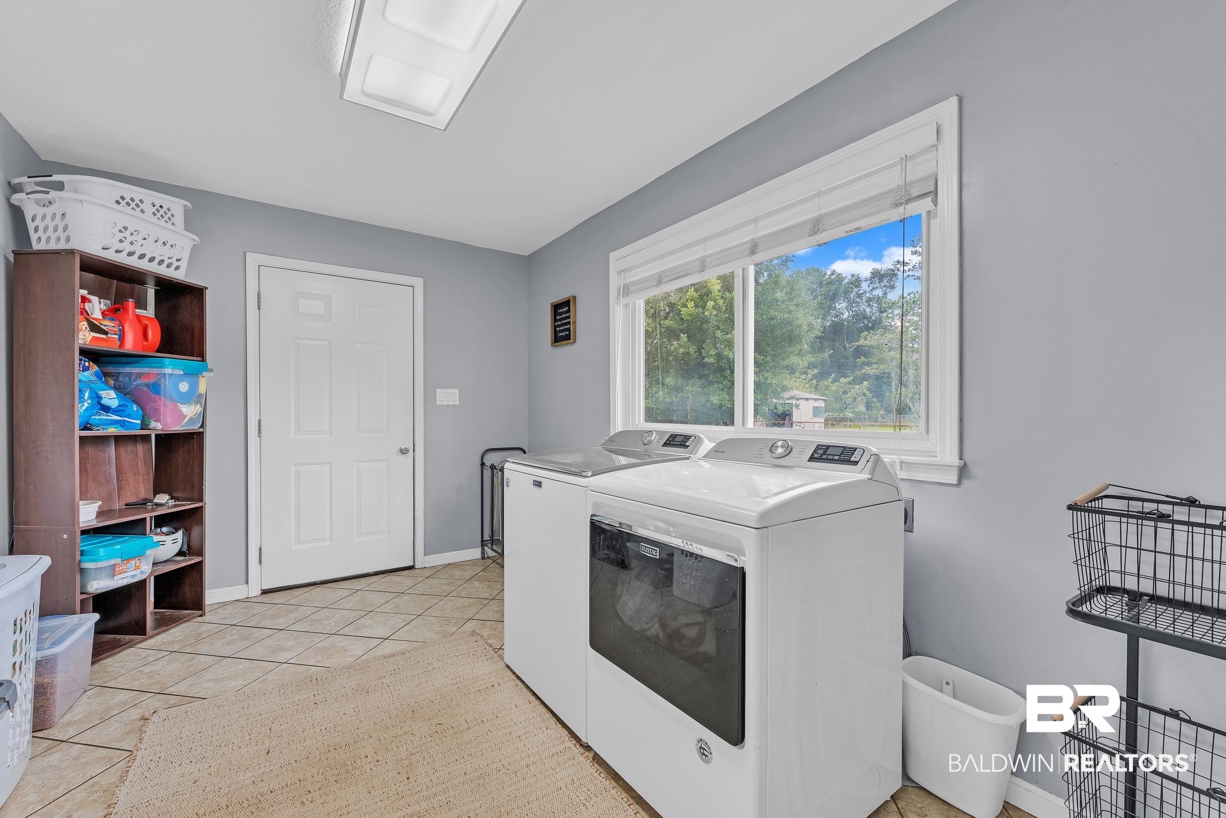 206 West Jackson Avenue Summerdale, AL 36580 - Photo 26 of 37 Laundry room featuring washer and dryer, light tile patterned floors, and baseboards