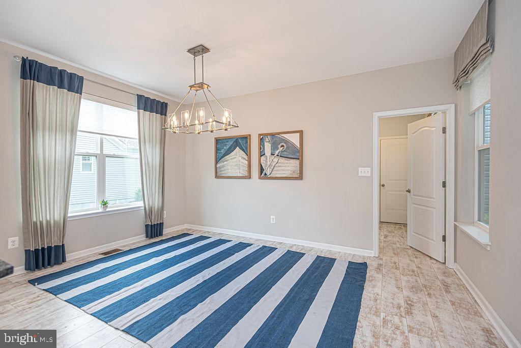 30134 Islander Beach Road Frankford, DE 19945 - Photo 18 of 73 a view of a bedroom with wooden floor and windows