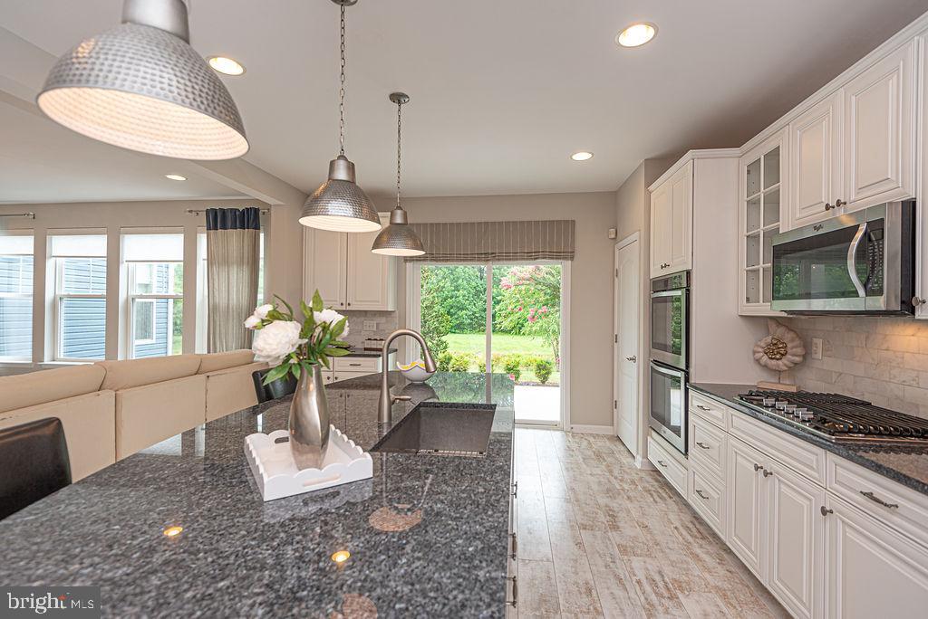 30134 Islander Beach Road Frankford, DE 19945 - Photo 19 of 73 a living room with furniture fireplace and a chandelier