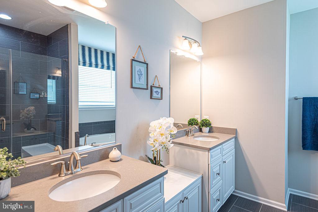 30134 Islander Beach Road Frankford, DE 19945 - Photo 28 of 73 a bathroom with a sink vanity granite tub and a mirror
