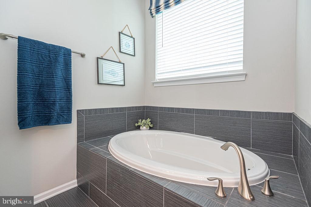 30134 Islander Beach Road Frankford, DE 19945 - Photo 29 of 73 a white bath tub sitting next to a white sink