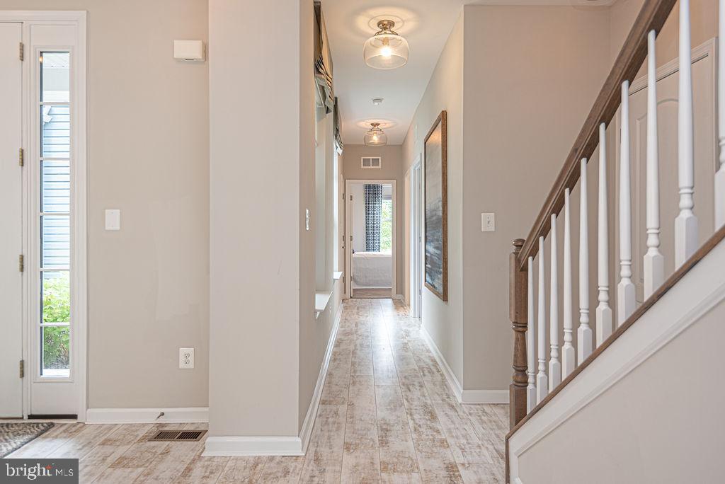 30134 Islander Beach Road Frankford, DE 19945 - Photo 34 of 73 a view of a hallway with wooden floor and staircase