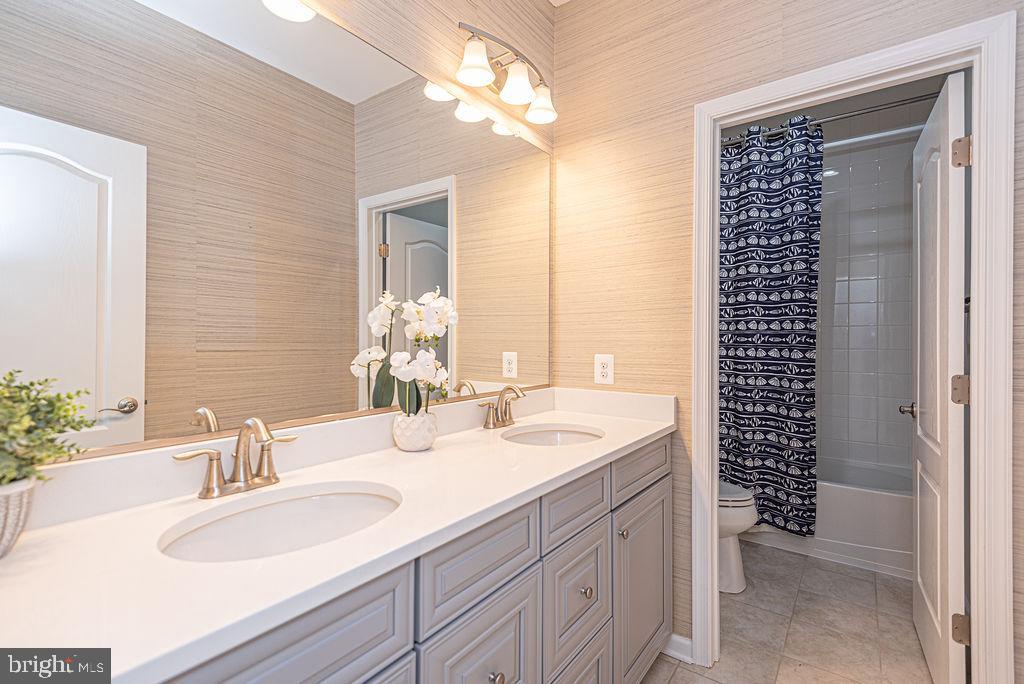 30134 Islander Beach Road Frankford, DE 19945 - Photo 38 of 73 a bathroom with a sink double vanity and a shower