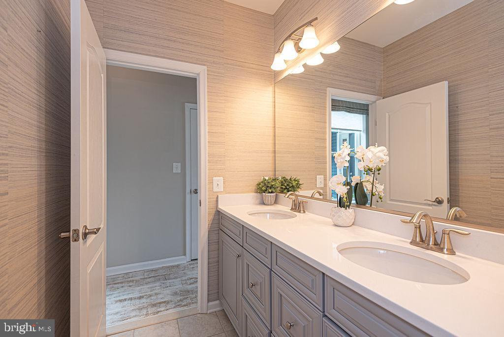 30134 Islander Beach Road Frankford, DE 19945 - Photo 40 of 73 a bathroom with double vanity and a mirror