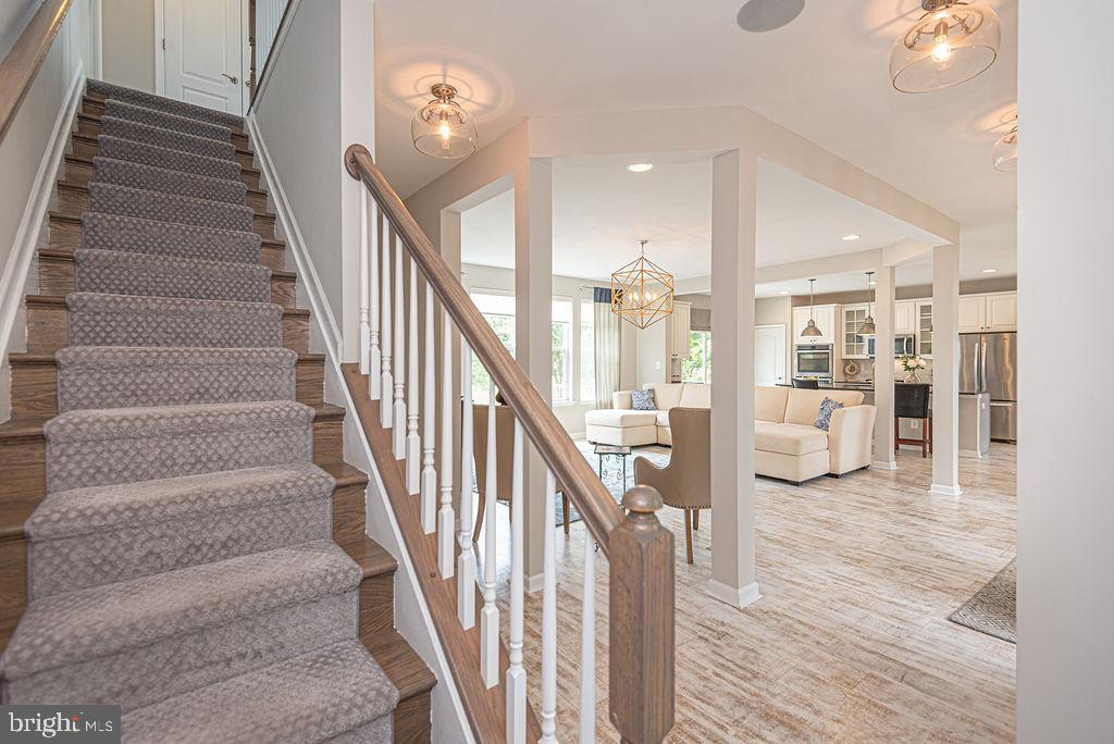 30134 Islander Beach Road Frankford, DE 19945 - Photo 42 of 73 a view of staircase with lots of frames and a rug
