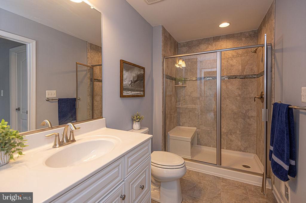 30134 Islander Beach Road Frankford, DE 19945 - Photo 47 of 73 a bathroom with a sink toilet and shower