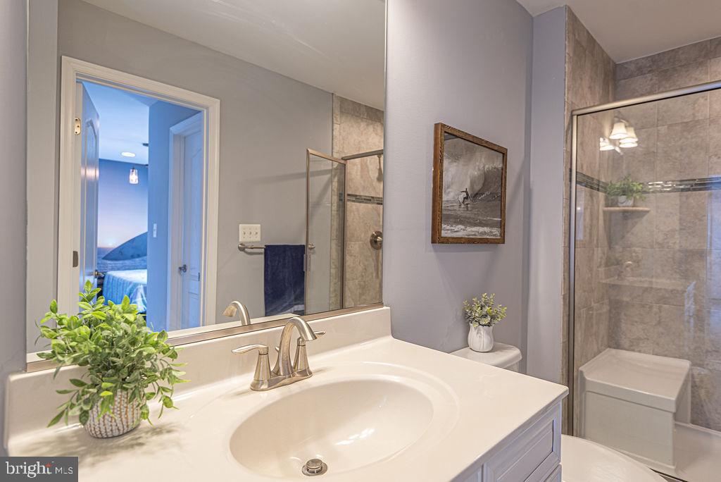 30134 Islander Beach Road Frankford, DE 19945 - Photo 51 of 73 a bathroom with a sink and a mirror