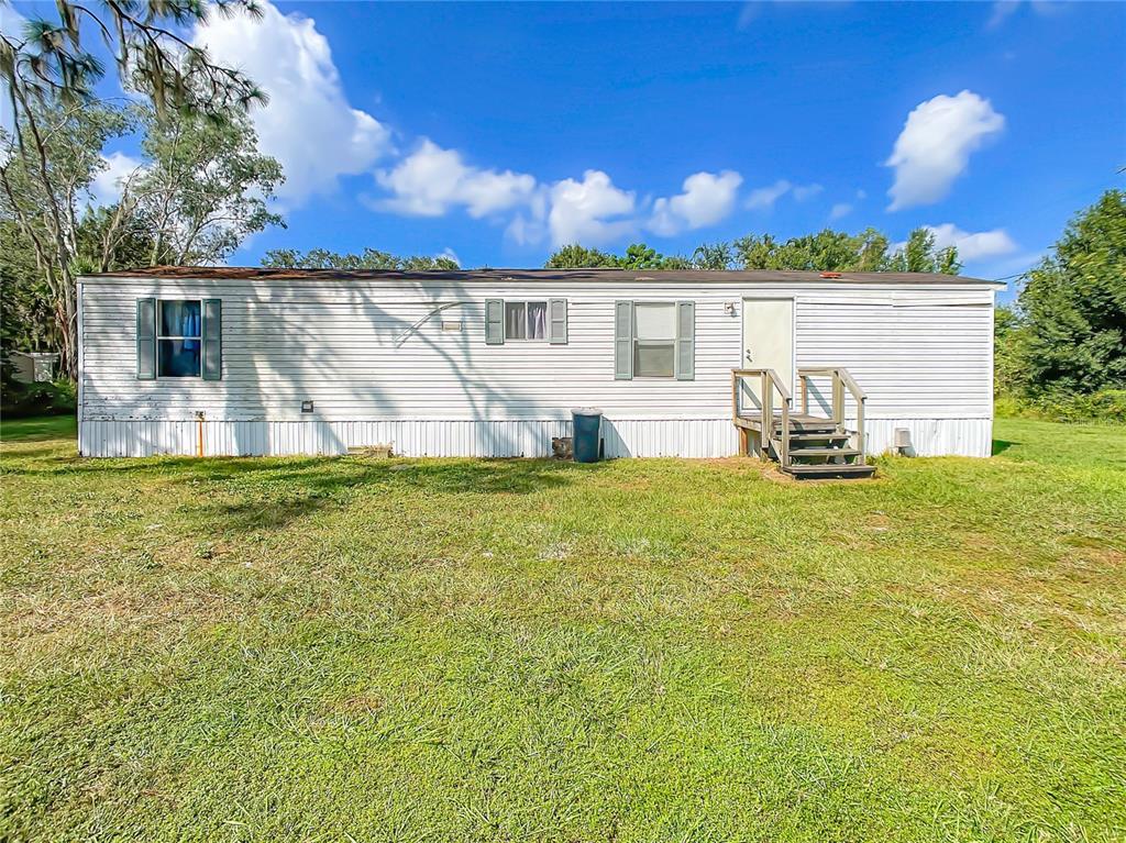 3636 Jordan Road Dover, FL 33527 - Photo 1 of 1 a front view of a house with a yard fountain and a large tree
