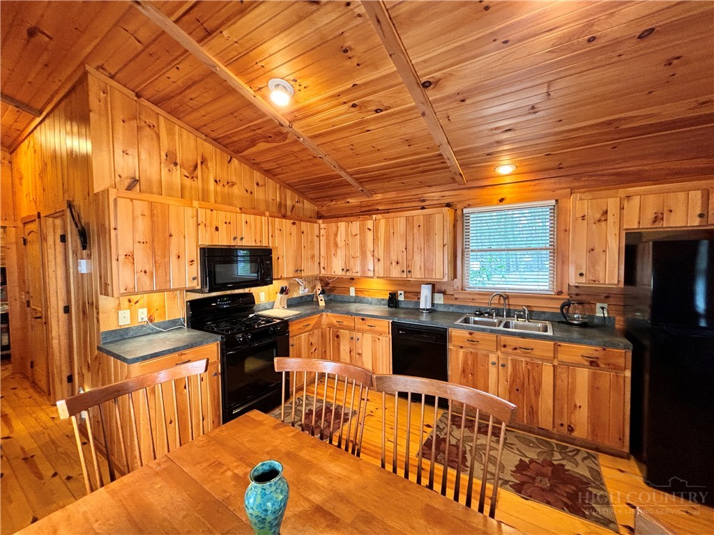 150 Turkey Ridge Crumpler, NC 28617 - Photo 24 of 40 a kitchen with stainless steel appliances wooden cabinets a stove top oven a sink and dishwasher