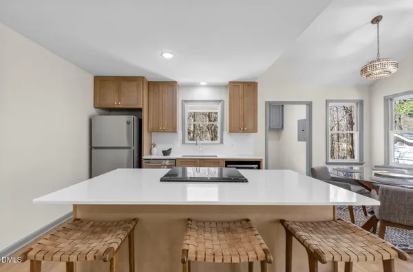 a living room with stainless steel appliances granite countertop furniture and a table