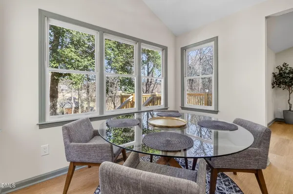 a dining room with furniture and wooden floor
