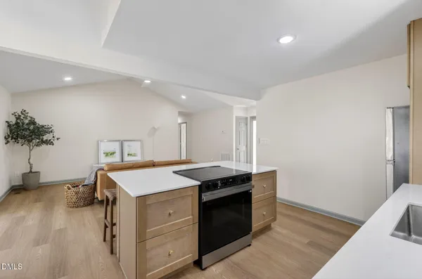 a kitchen that has a sink and a stove in it