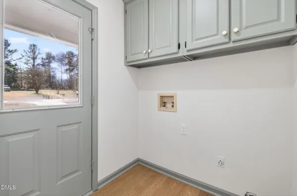 a view of a closet with wooden floor