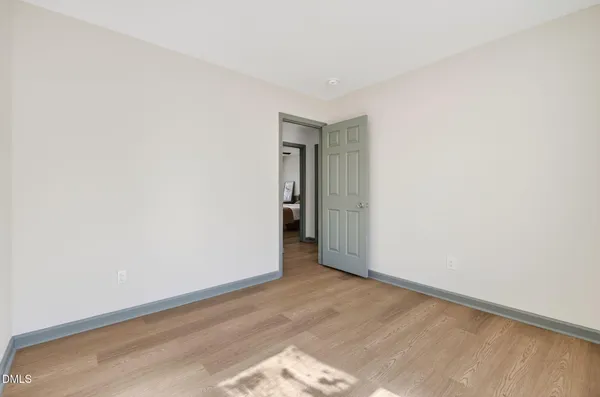 a view of an empty room and wooden floor